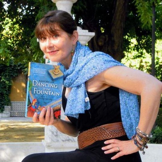 Karen McCann holding her book, Dancing in the Fountain