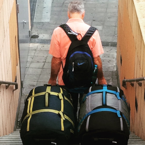 Michael Campbell with luggage / Lessons Learned for 212 Airbnbs / The Senior Nomads / Karen McCann / EnjoyLivingAbroad.com